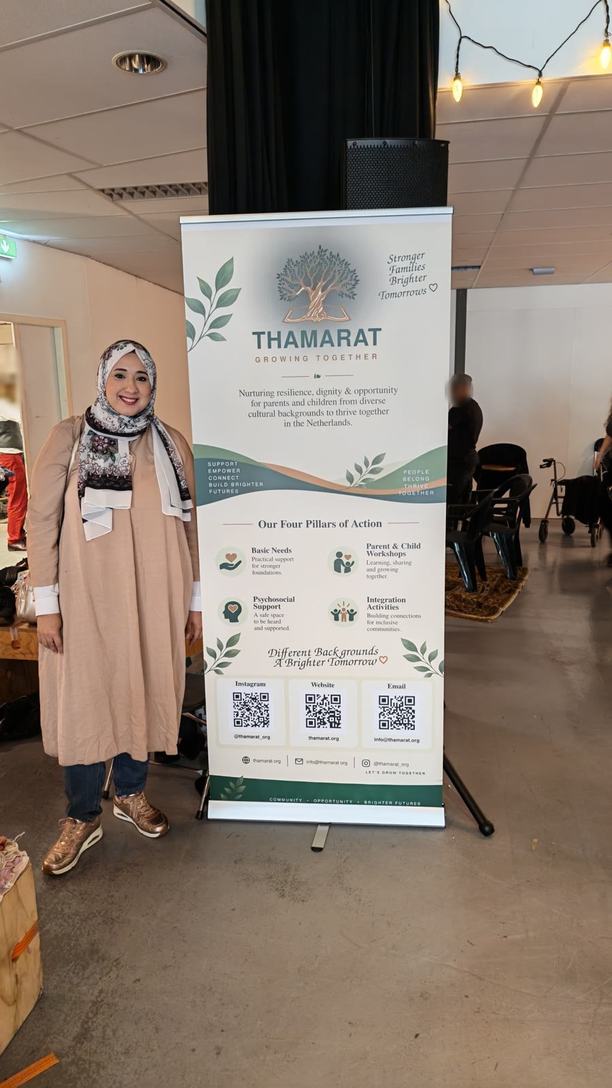 A tall Thamarat banner standing in a hall.